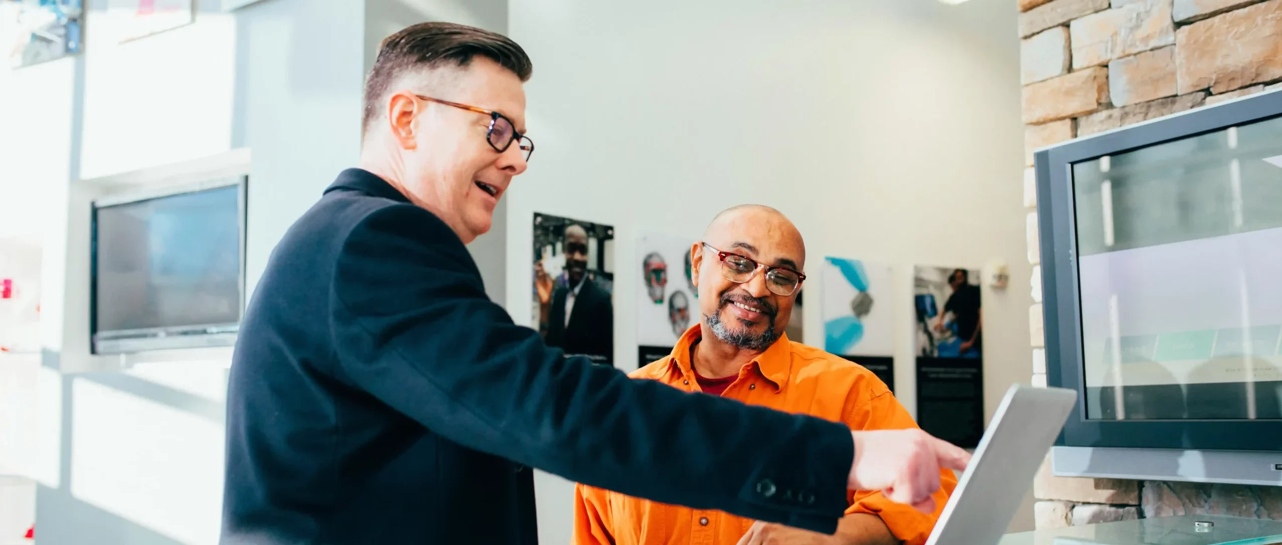 Happy businessmen in front of a laptop